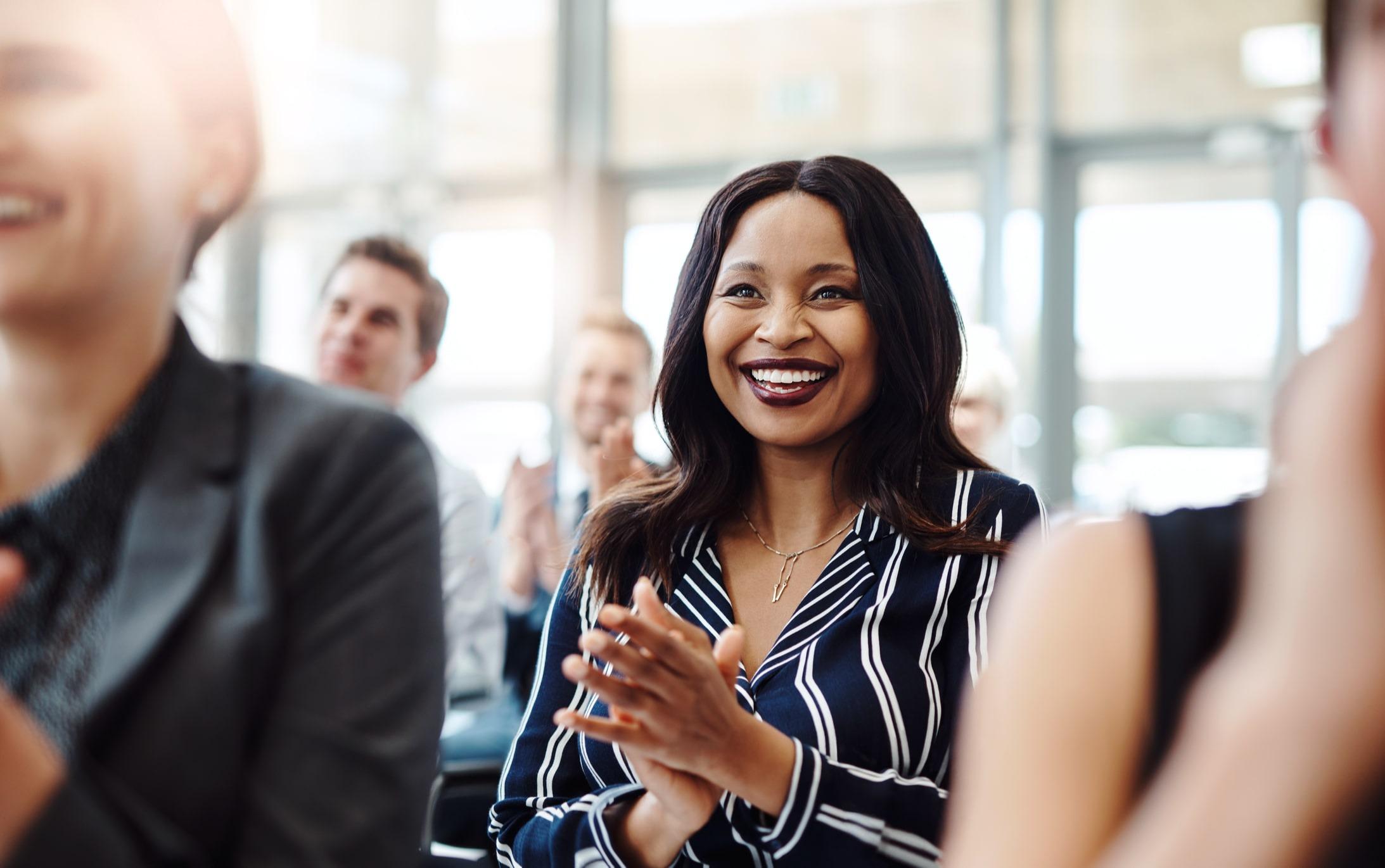 A woman smiling during a professional event